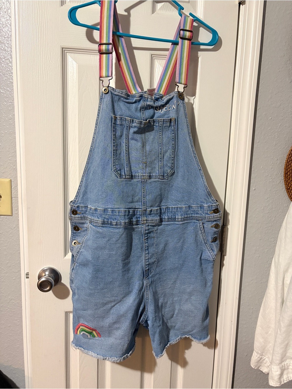 Womens Rainbow-Trim Denim Short Overalls with Rainbow Straps, says “Queen”. Xl